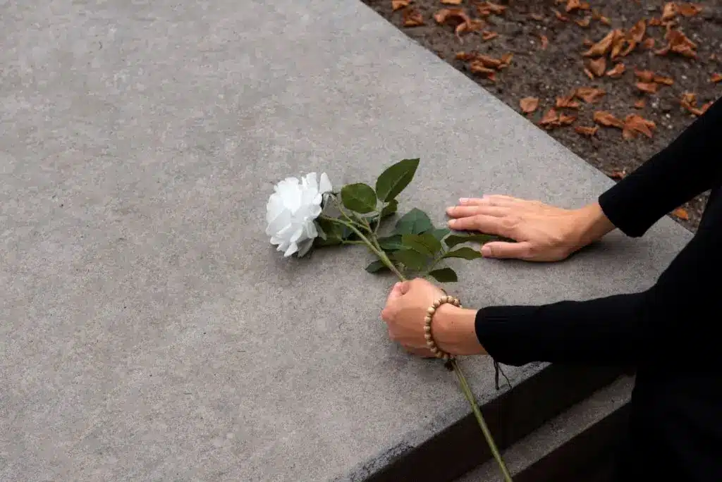 A flower on the grave,, symbolizing love after loss, healing after grief, and emotional strength to move on.
