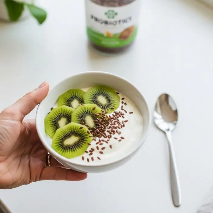 Nonfat Greek yogurt protein bowl with kiwi and flax seeds showing probiotics benefits for gut health and digestion